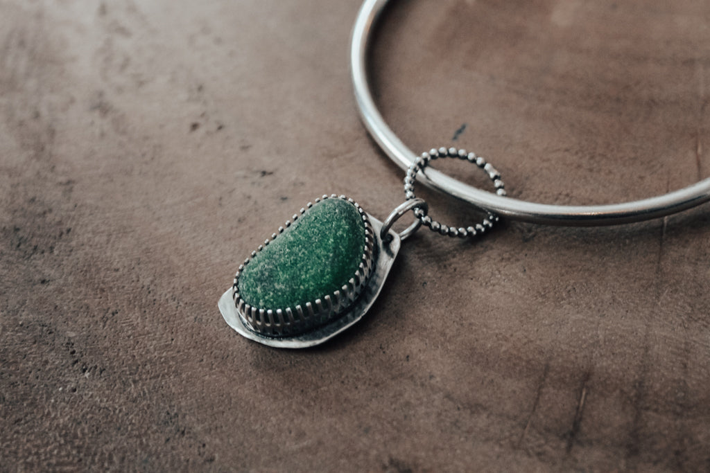 green sea glass charm and thick silver bangle