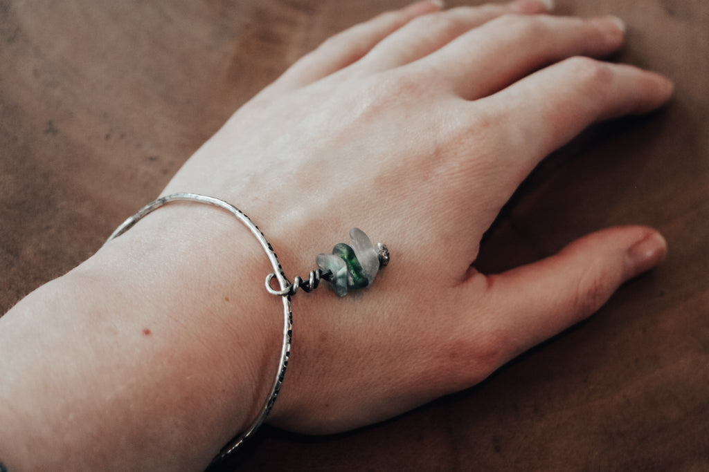 textured silver bangle with sea glass charms