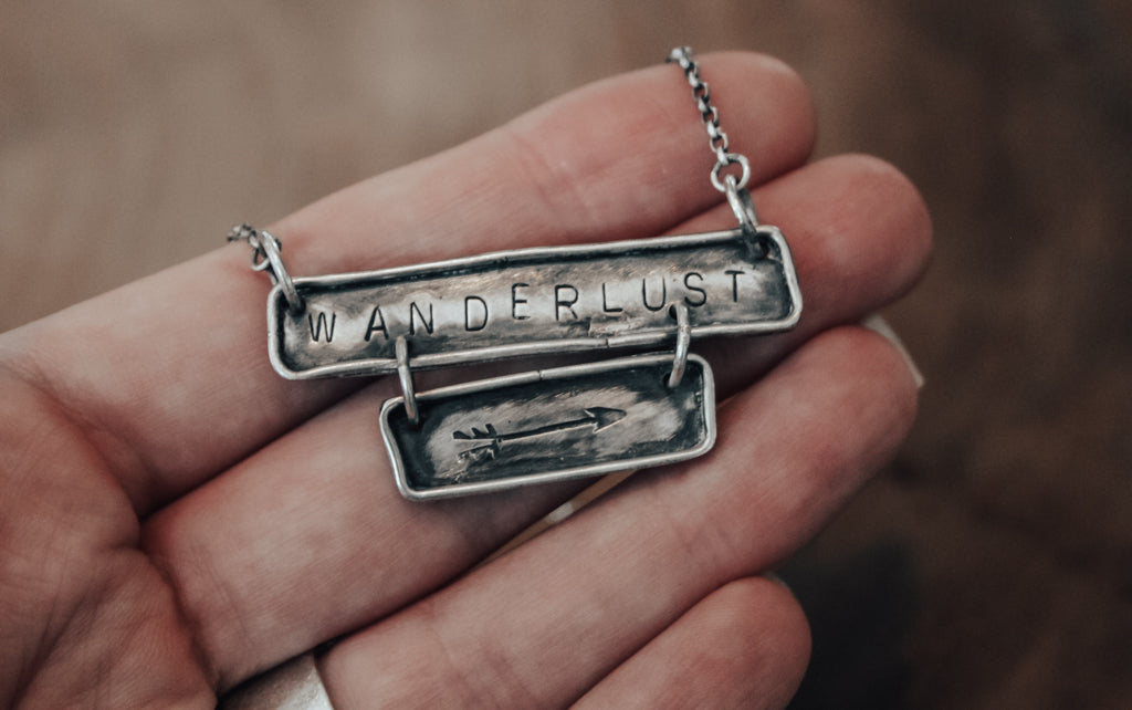 hand stamped wanderlust necklace with arrow detail